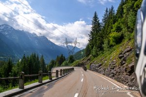 Riding through Alps by motorcycle, another riders on the road